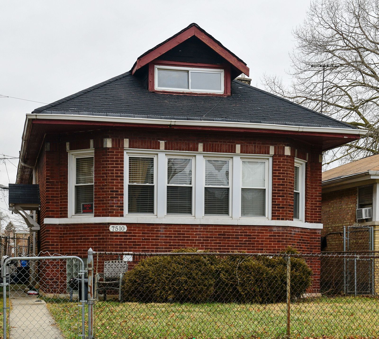 Brick Chicago bungalow on South Wolcott Avenue with a hipped roof and dormer