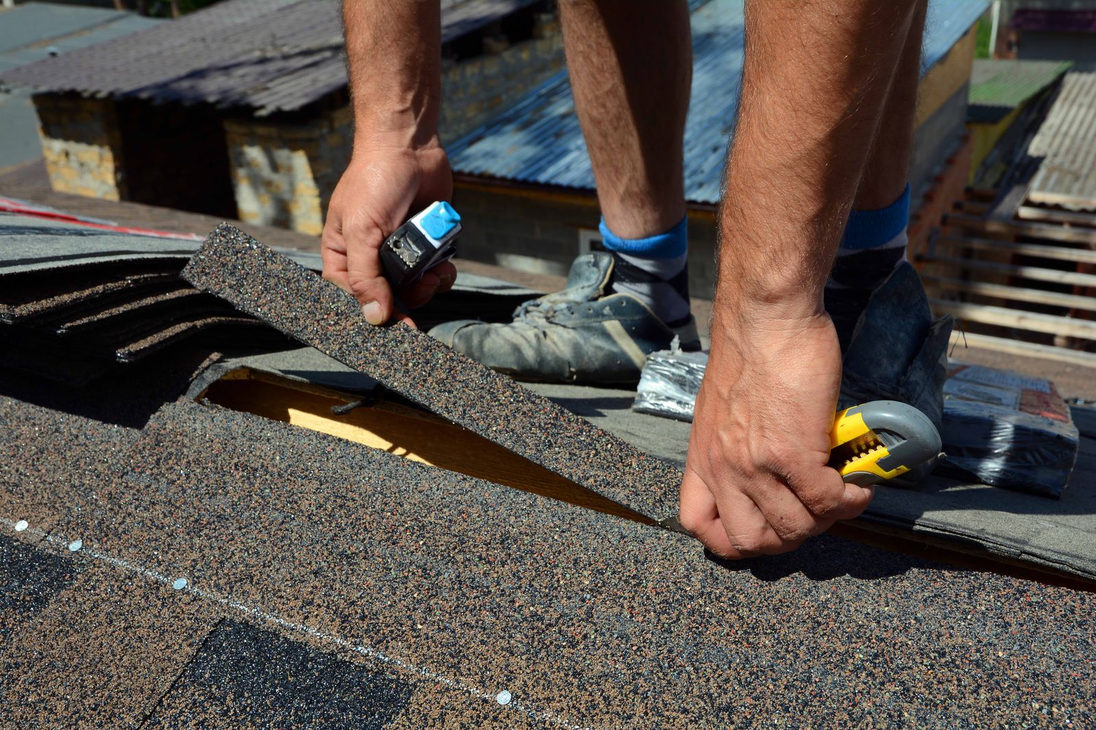 Hands fitting an architectural shingle into a course