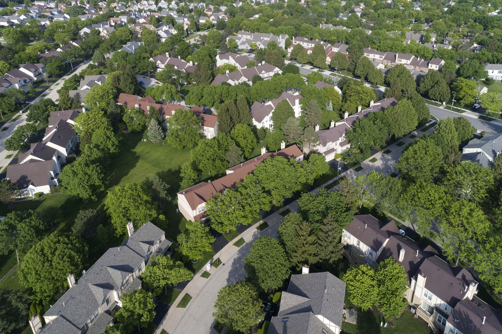 Aerial view of a row of townhouses with new shingle roofs