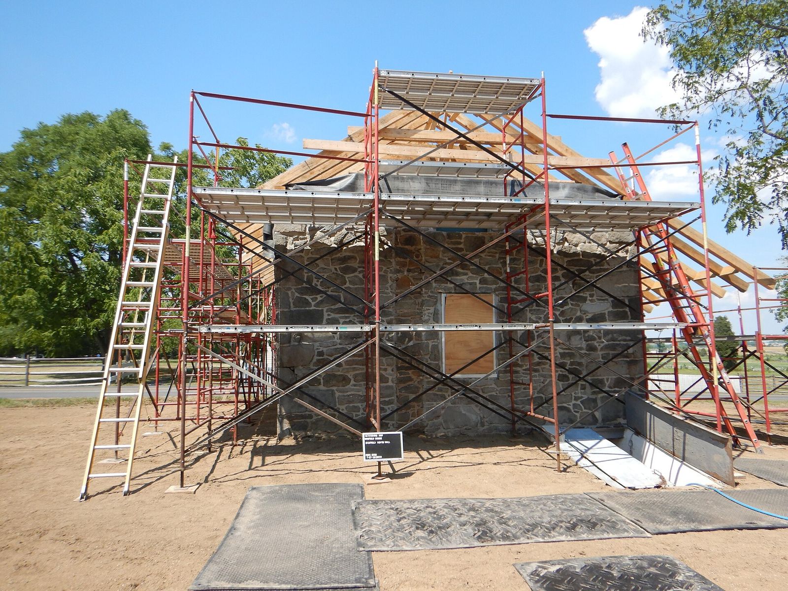 Scaffolding against a brick building with a crew at work
